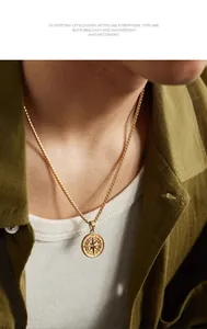 Close-up of golden stainless steel compass pendant on a classic square pearl chain