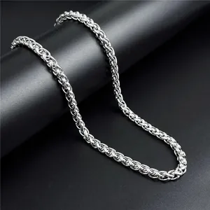 Macro detail of 5mm silver stainless steel spiga chain with polished basket weave texture