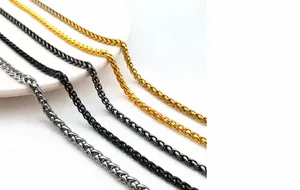 Close-up of woven wheat chains in gold, silver, black, and gunmetal stainless steel