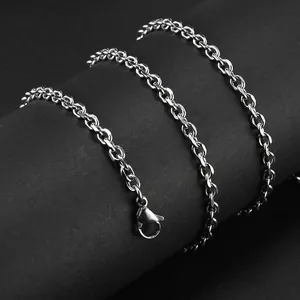 Macro shot of polished stainless steel link chain necklace with lobster clasp on black background