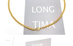Close-up of golden spiga chain with detailed weave texture and lobster clasp closure