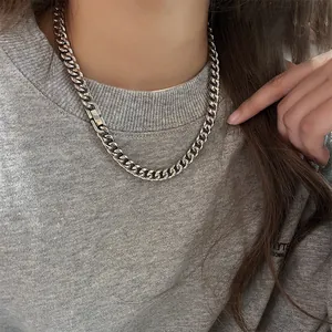 Detail of chunky stainless steel Cuban link necklace with stylish square box clasp