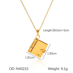 Detailed view of golden book locket necklace with size specs on white background