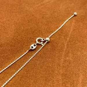 Adjustable silver needle chain necklace with pig nose detail and sliding bead closure