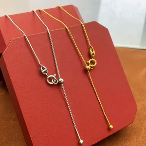 Adjustable 18K gold and silver plated box chains on a luxury red octagon gift box