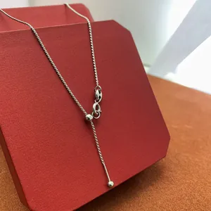 Detailed shot of silver adjustable slider chain with lobster clasp on jewelry box