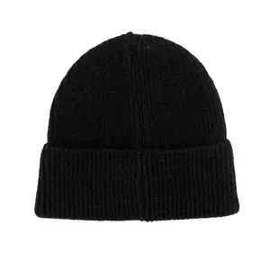 Primer plano de un gorro de punto negro con textura de canalé vertical y borde doblado