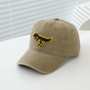 Gros plan détaillé sur casquette vintage en coton kaki avec broderie de dinosaure