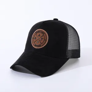 Detail of black mesh baseball cap with suede front and Enjoy Life circular leather patch