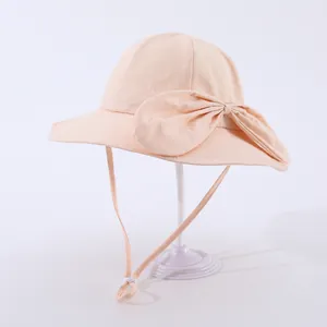 Detail view of pink kids sun hat with oversized bow and adjustable chin strap