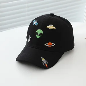 Detailed close-up of cosmic alien and rocket embroidery on a black cotton kids baseball cap