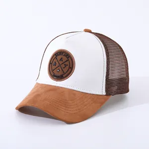 Close-up of brown suede brim and white mesh trucker hat with Enjoy Life patch