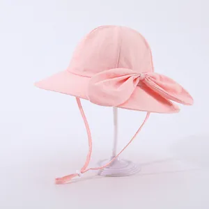 Pink quick-dry sun hat for girls featuring a large bow and adjustable windproof strap