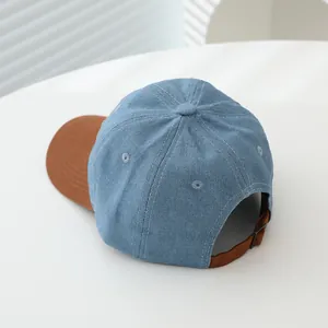 Classic denim kids baseball cap with dinosaur embroidery and brown contrast brim