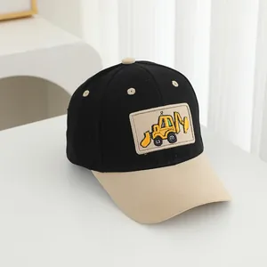 Close-up of kids excavator embroidery patch on a black and yellow baseball cap