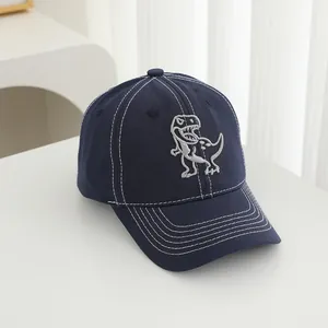 Detailed view of T-Rex embroidery and white contrast stitching on the navy cotton cap