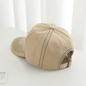 Khaki cotton baseball cap for kids with black contrast stitching and a metal buckle
