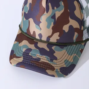 Detail of camouflage trucker hat featuring green braided rope and white mesh back