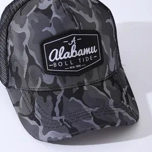Detailed close-up of camouflage mesh trucker hat with embroidered A patch and stitching