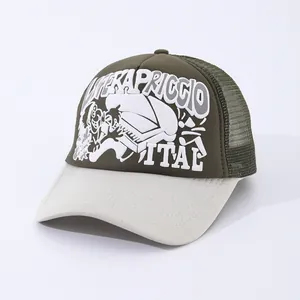 Close-up of a two-tone trucker hat featuring green mesh and Kapriccio piano print