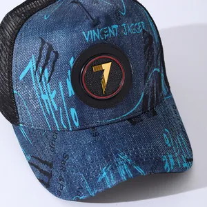 Close-up of denim graffiti baseball cap featuring rubber logo and breathable mesh