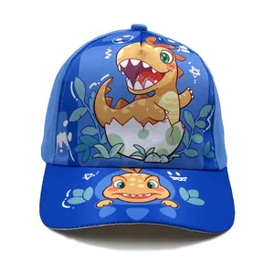 Blue kids baseball cap featuring cartoon dinosaur hatching from egg shell on front