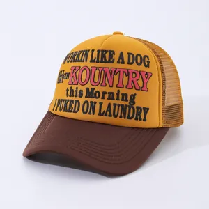 Close-up of vintage yellow and brown mesh trucker hat with retro slogan print