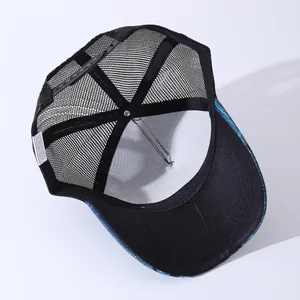 Interior view of trucker hat showing breathable black mesh and 100% cotton wash label