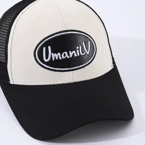 Classic black and white trucker hat with UmaniLV embroidered patch and mesh back