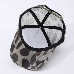 Detail of breathable mesh backing and adjustable green snap closure on trucker hat