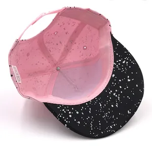 Adjustable kids baseball cap with pink crown and white splatter pattern inside