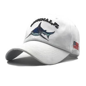 Detail of shark embroidery and American flag patch on white cotton baseball cap