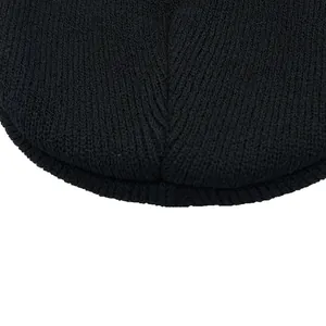 Close-up of black knitted beanie showing fine stitch texture and quality craftsmanship