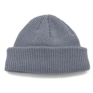 Neutral grey ribbed knit beanie hat with classic rolled edge cuff on white background