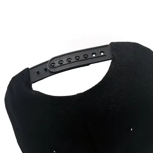 Adjustable snapback closure detail on black cotton USA baseball cap with premium texture