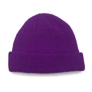 Detailed view of purple knit beanie with chunky ribbed texture and folded brim edge