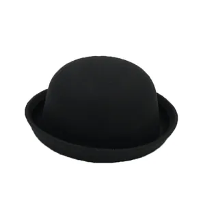 Detail view of the classic black wool felt bowler hat with a rounded crown and rolled brim