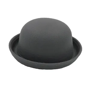 Detailed close-up of dark grey wool felt bowler hat with rolled brim and fine texture