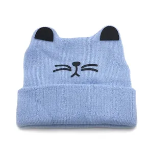 Light blue knit baby hat with cat ears and embroidered whiskers for autumn and winter