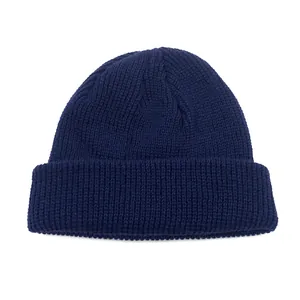 Detailed view of the dark blue knit beanie showing thick texture and ribbed design