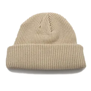 Close-up of beige ribbed knit beanie featuring a classic cuffed design and soft yarn texture