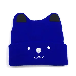 Detail of royal blue knit baby beanie with cute bear embroidery and 3D ears