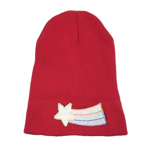 Red knit beanie with embroidered shooting star pattern for winter ski activities