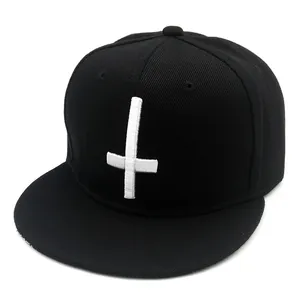 Black snapback baseball cap featuring a 3D embroidered white cross on cotton twill