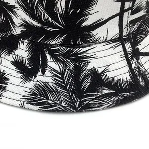Tropical coconut tree print bucket hat in retro minimalist style with black and white palm pattern