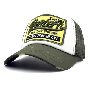 Close-up of vintage Western embroidery and mesh detail on an olive green trucker hat