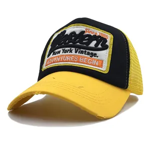 Detail of vintage New York embroidered patch and distressed brim on trucker hat