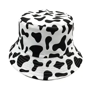 Reversible cow print bucket hat in black and white canvas for sun protection