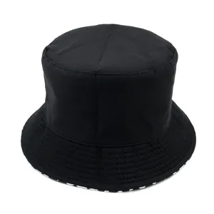 Classic black reversible bucket hat with paisley pattern and checkered inner brim detail