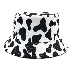 Double-sided cow print bucket hat with black and white animal pattern for outdoor sun protection